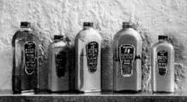 A black and white image of old-fashioned Meguiar's bottles.