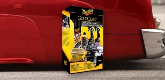 The rear fender of a lowered red classic car with a superimposed product image of Meguiar's® Gold Class Complete Car Care Kit.