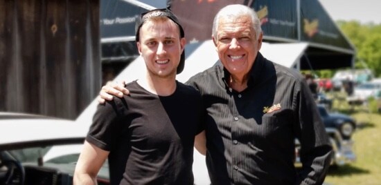 A picture still of Barry Meguiar standing with contest winner Josh Vandenberk.
