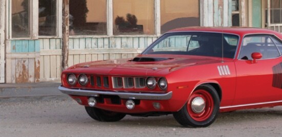 A classic red and black muscle car.
