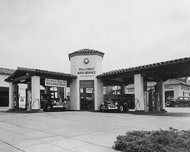 A black and white image of an old fashioned auto shop.